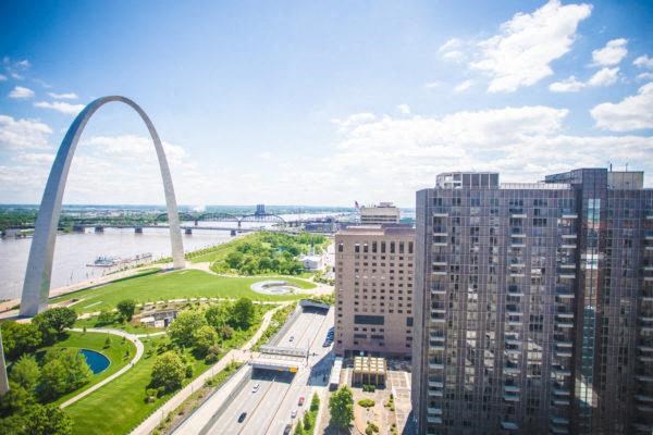 Aerial view of Mansion House Apartments, freeway, riverfront and cityscape with the gateway arch in the background
