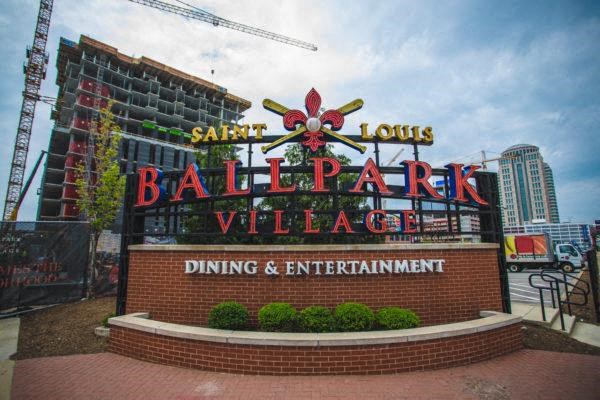 a sign that is on the side of Ballpark Village Dining and Entertainment Center on Broadway