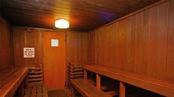 a sauna with wooden benches and a light on the ceiling