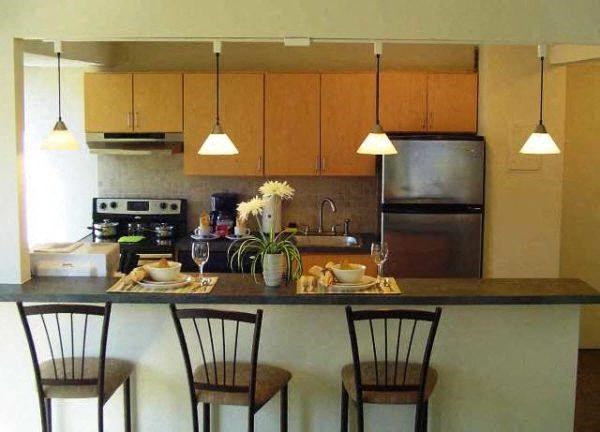 a kitchen with a counter and three chairs in a 1050 two bedroom apartment