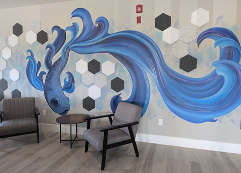 Common Area seating with a mural of a large blue fish