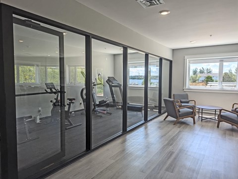 A spacious gym with treadmills, exercise bikes, and other equipment.