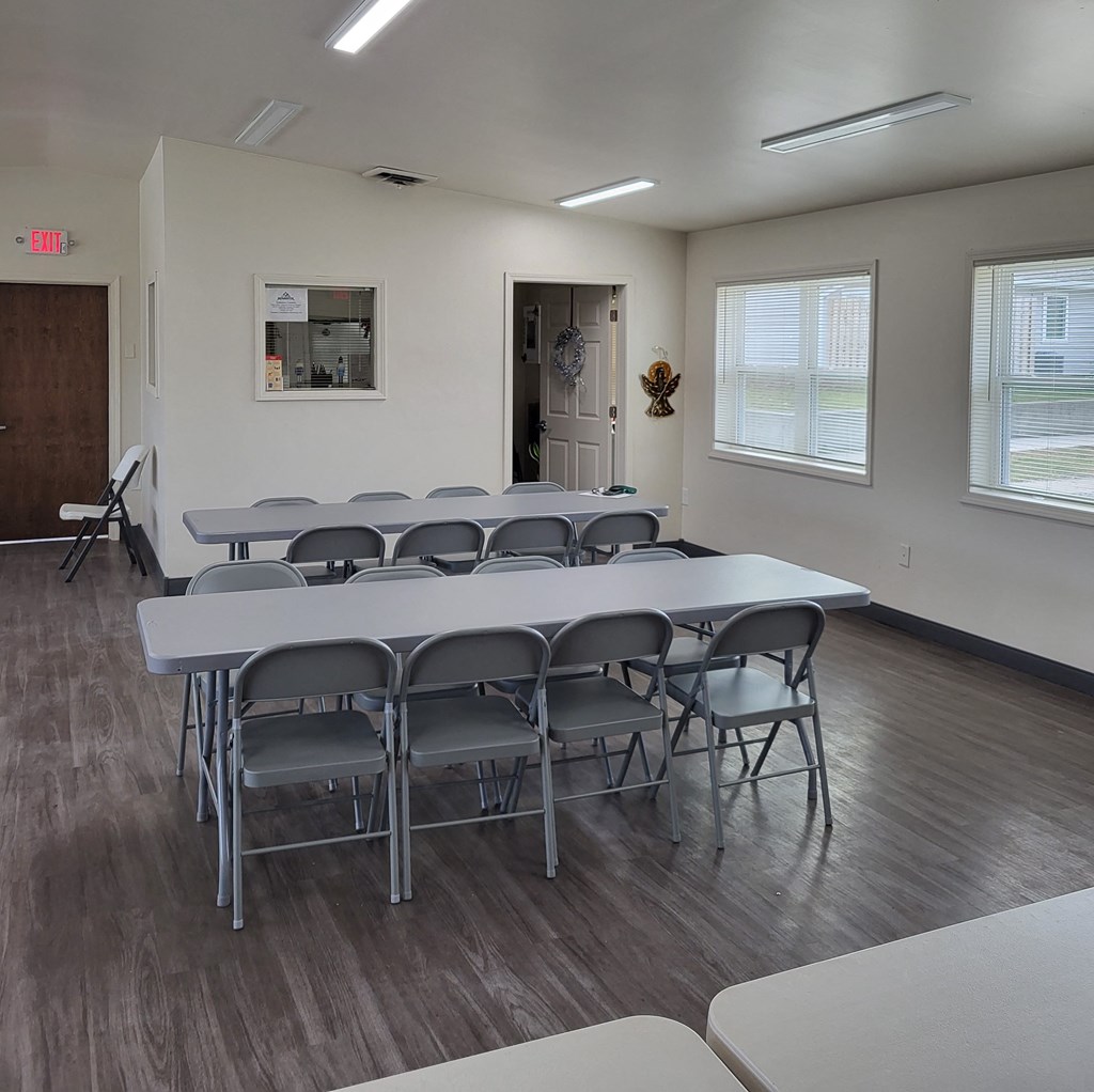 a conference room with a table and chairs in it
