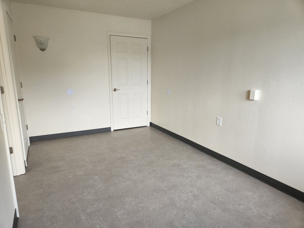 a room with a white wall and a white door