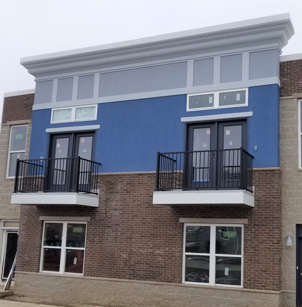 a blue building on the side of a brick building