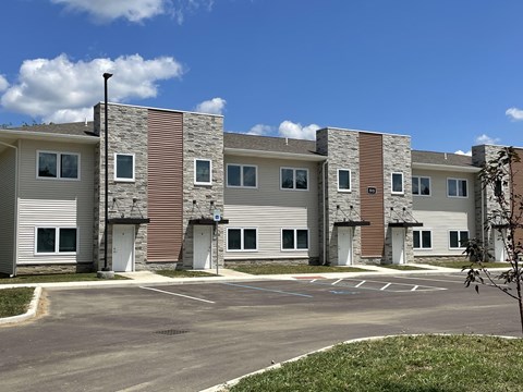 an apartment building with an empty parking lot