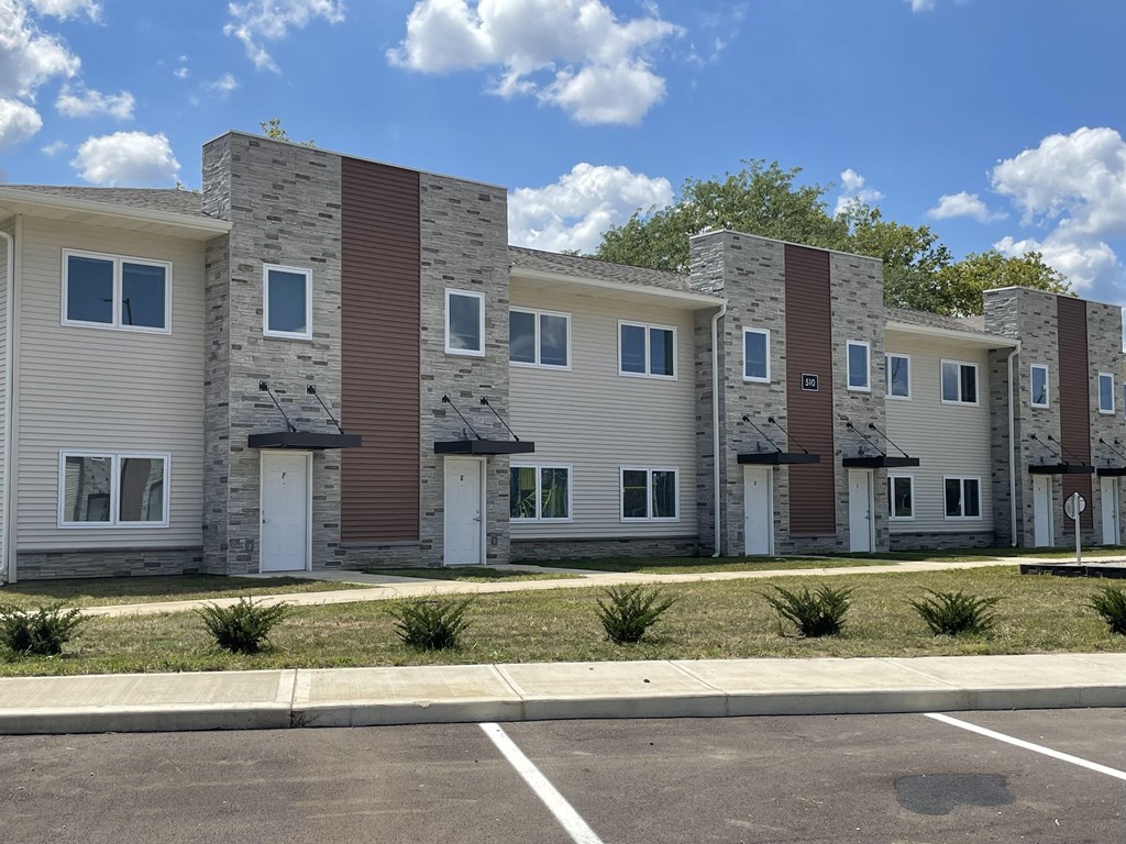 an image of a row of apartment buildings on a city street