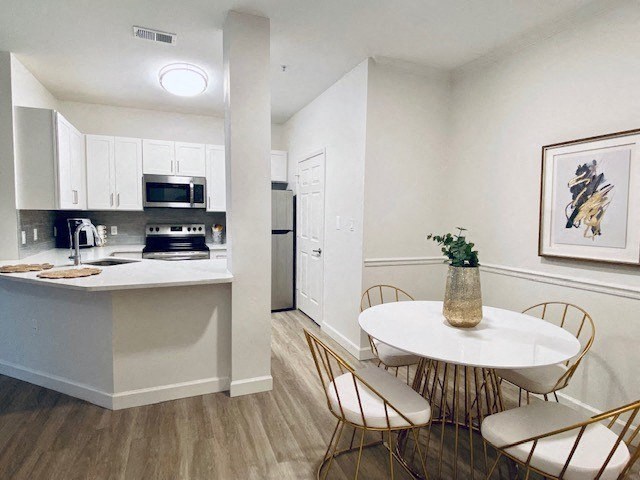 kitchen and dining room with a table and chairs at Mainstreet Apartments, Clearwater, 33756