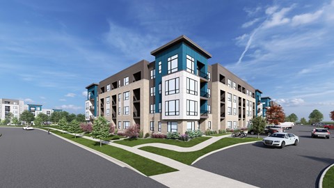 A modern apartment building with a parking lot in front.
