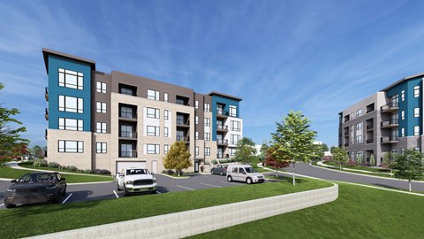 A modern apartment complex with cars parked in the driveway.