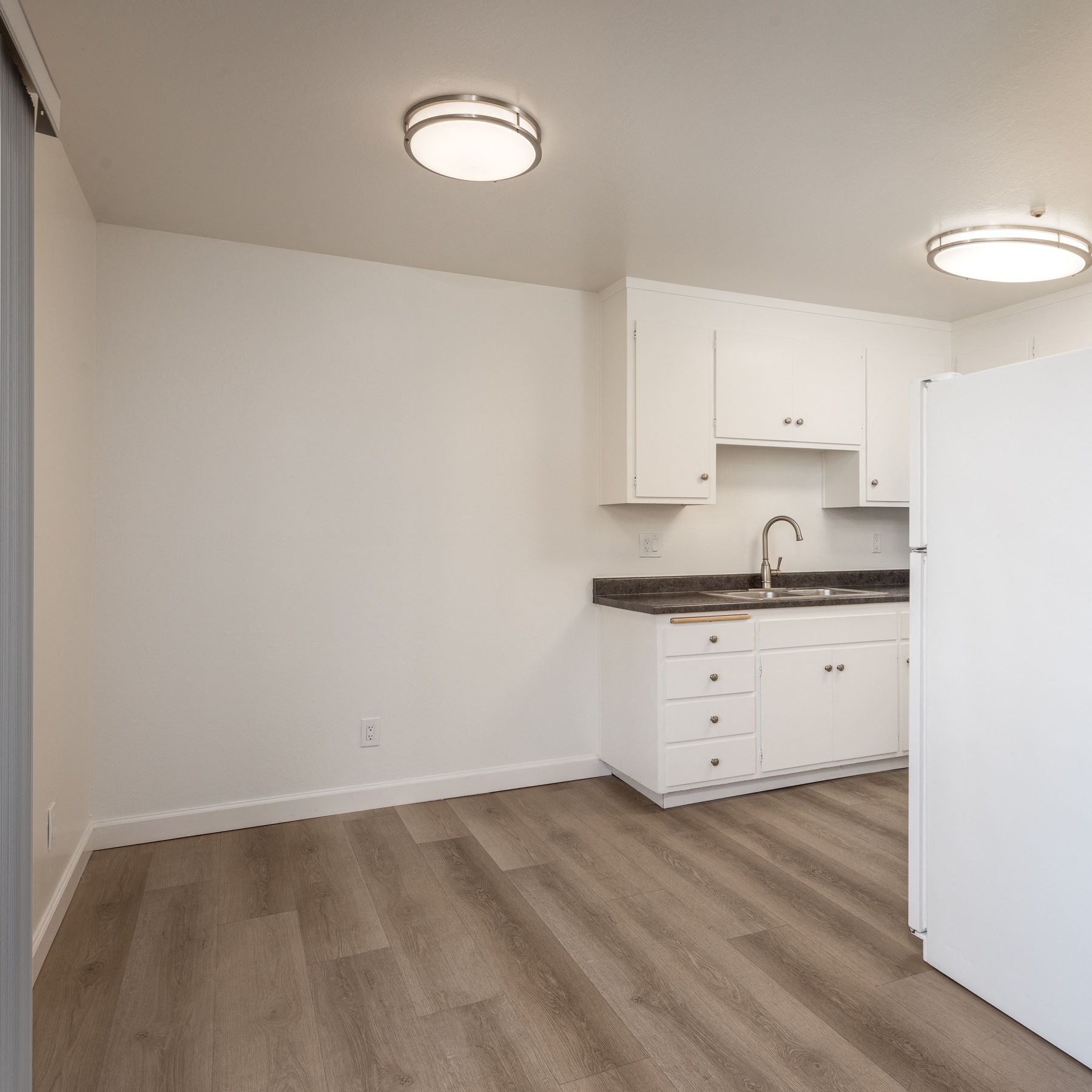 Dining Room of a Downstairs 2 BRM Apartment with a View of the Kitchen with Original Amenities