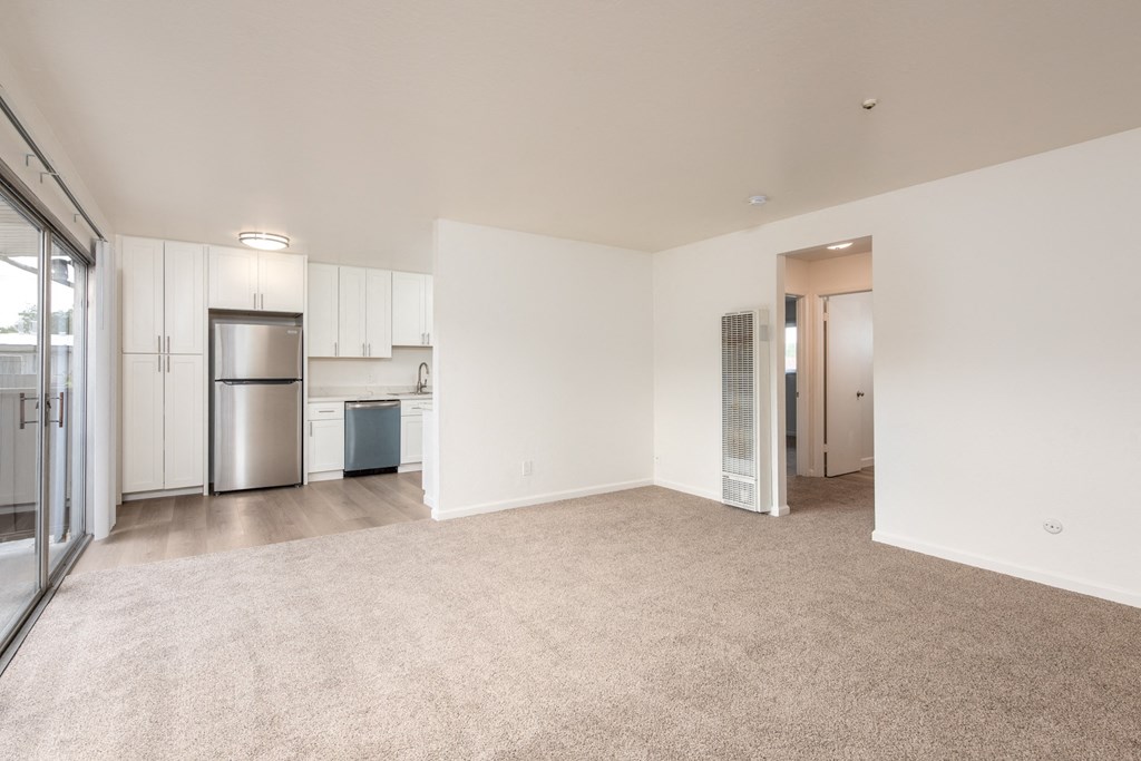 Living Room of an Upstairs 2 BRM Apartment with a View of the Kitchen and Upgraded Amenities