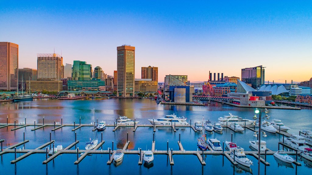 a view of the harbor and skyline at dusk