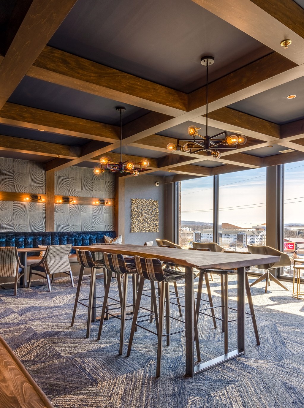 a dining room with tables and chairs and a large window