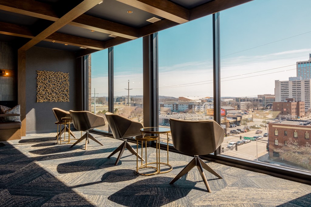 a group of chairs in a room with a view of a city