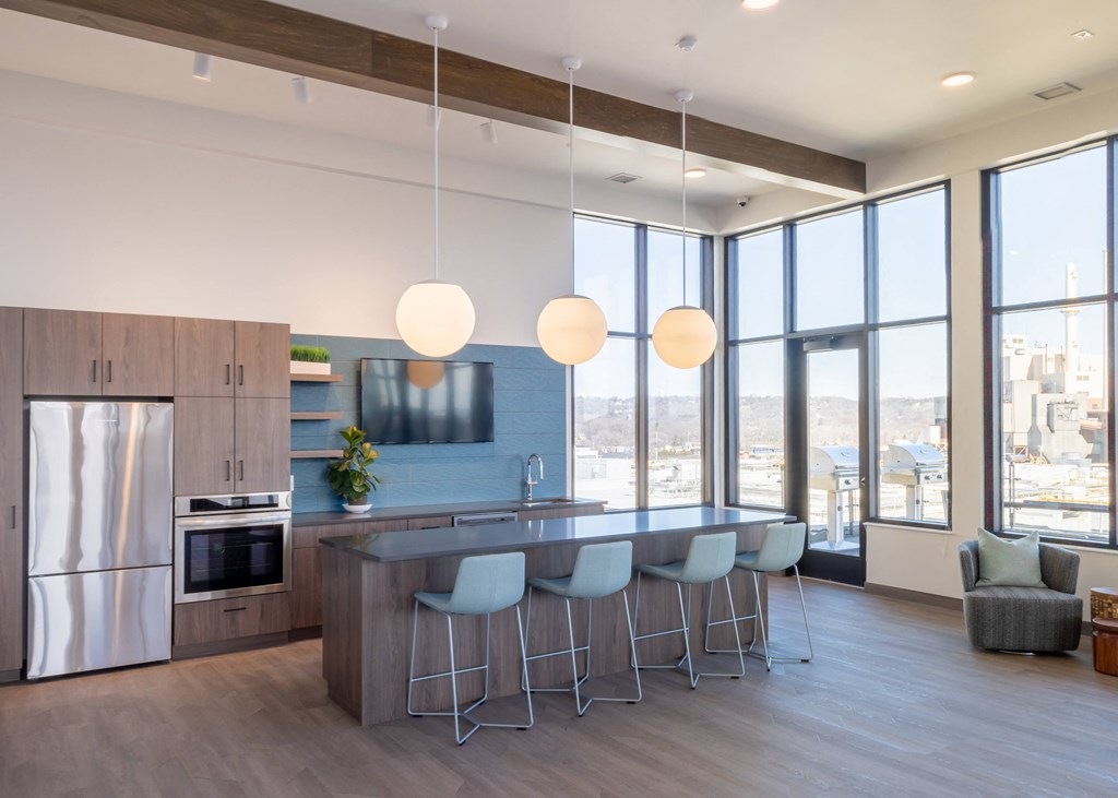 a kitchen with a large island and a group of chairs
