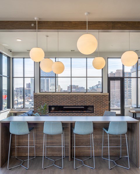 a kitchen with a marble counter top and blue chairs