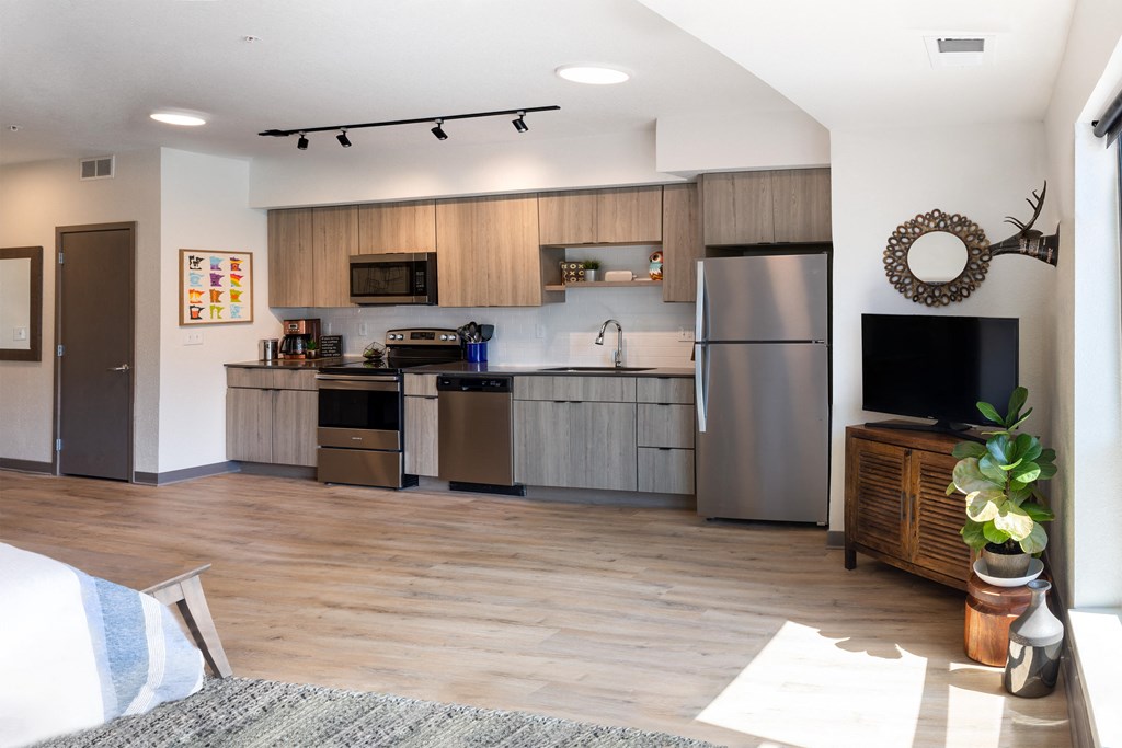a kitchen with stainless steel appliances and wooden cabinets