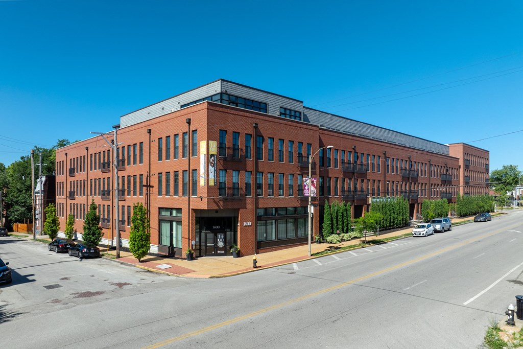 a large brick building on the corner of a street