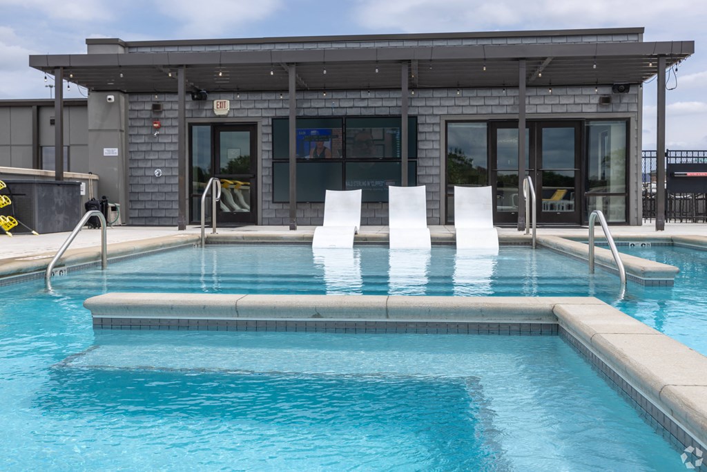 a swimming pool with a building in the background