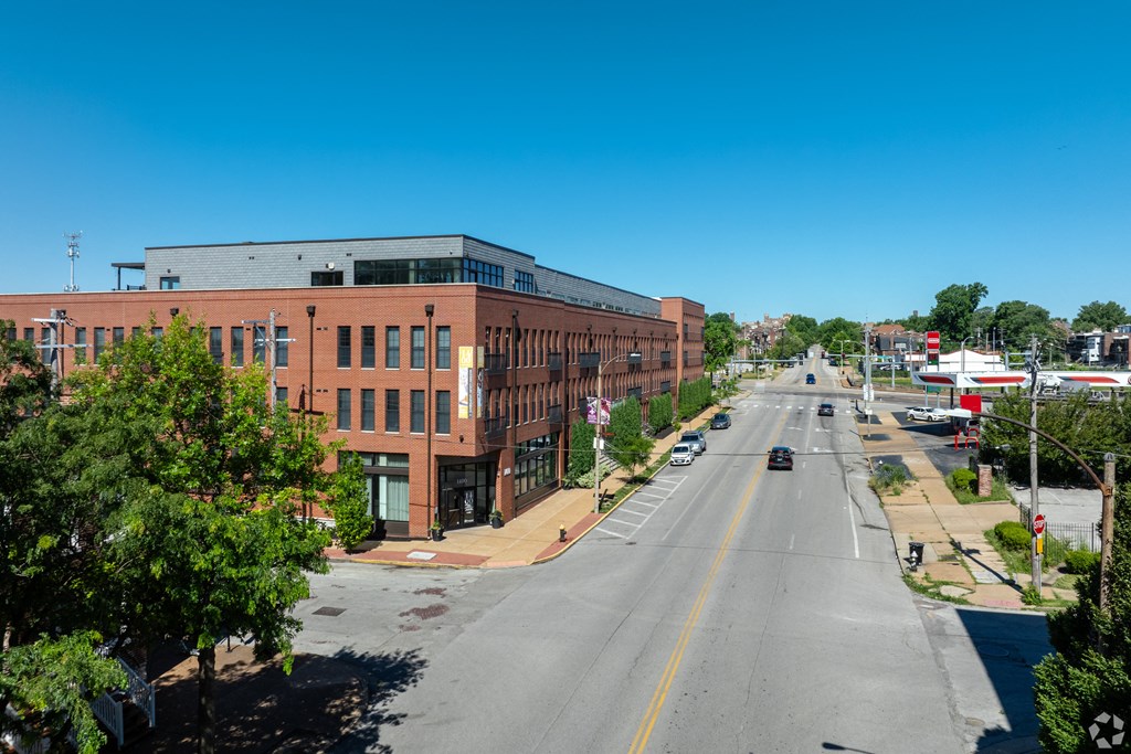 an aerial view of a city street with a brick building