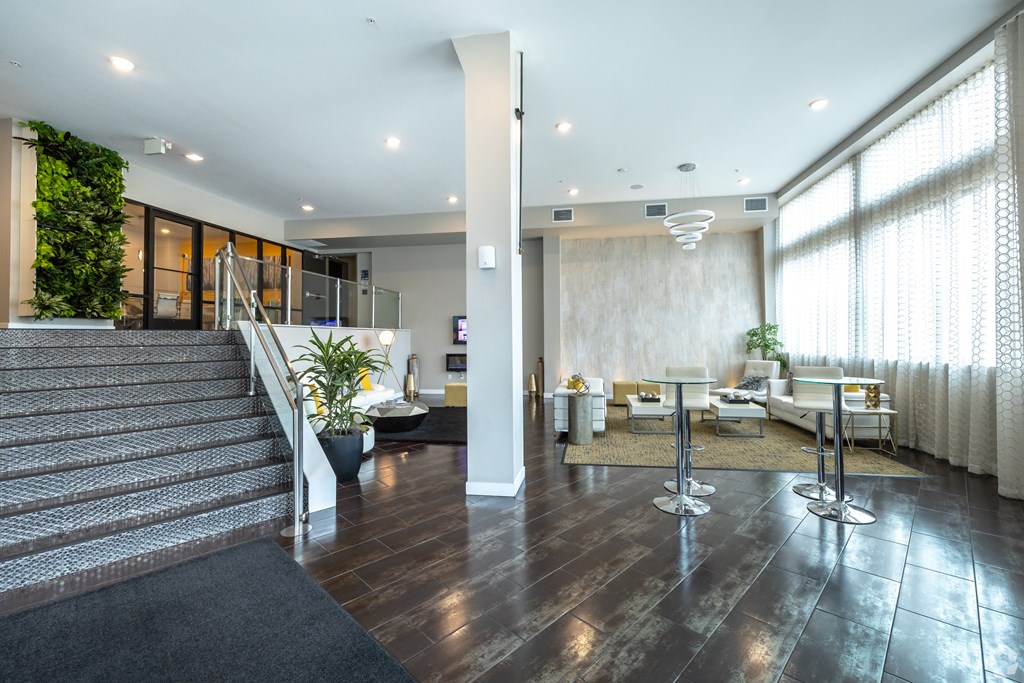 a lobby with a reception area and a staircase