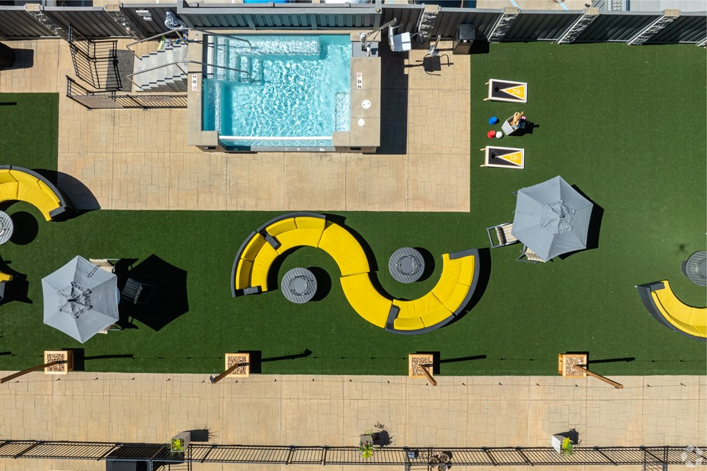 an aerial view of a swimming pool with umbrellas