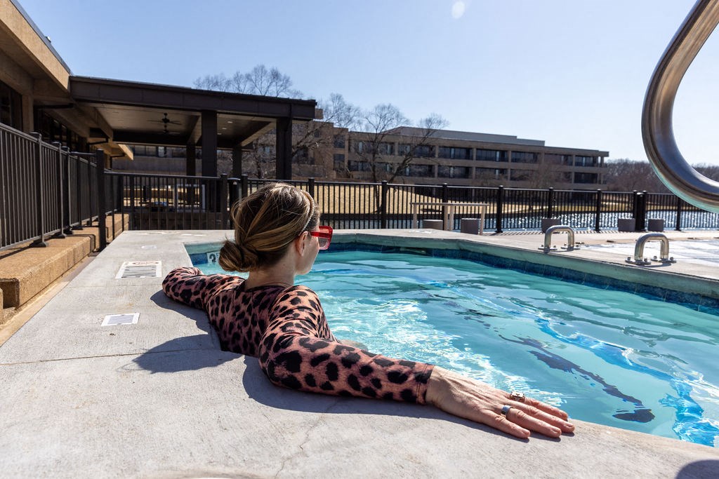 a woman relaxing in the pool at a hotel at The Residences at Tesson Ridge, Missouri, 63128