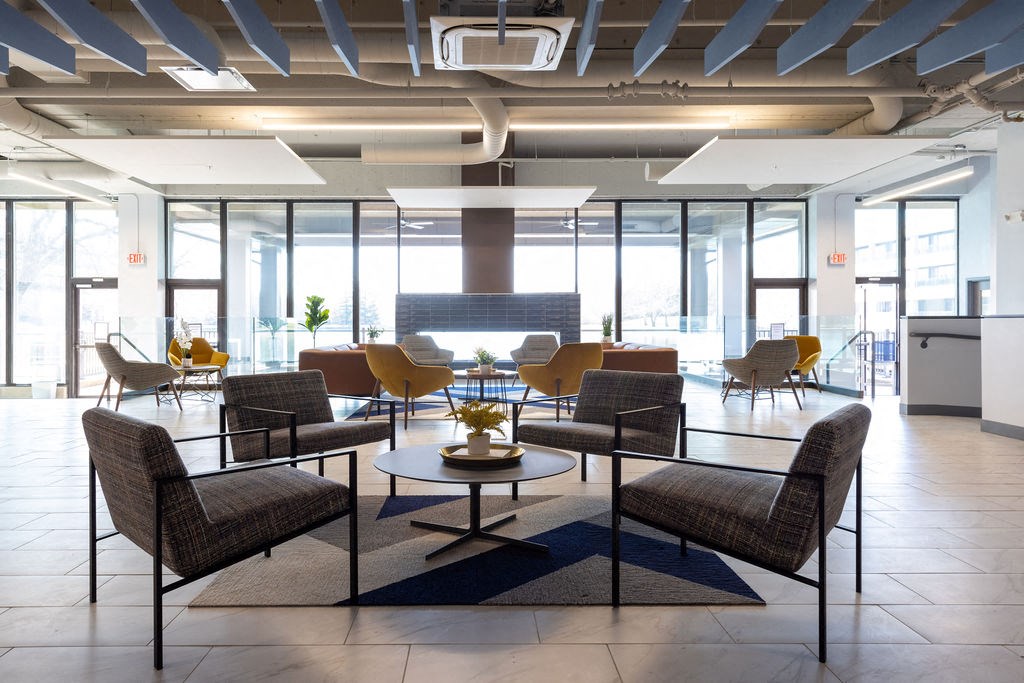 a large lobby with chairs and a table at The Residences at Tesson Ridge, Saint Louis, Missouri