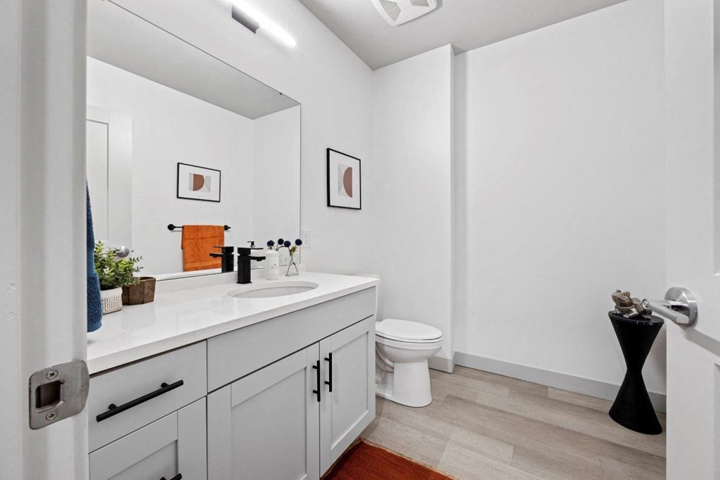 a bathroom with a sink and a toilet and a mirror at The Residences at Tesson Ridge, Saint Louis, 63128