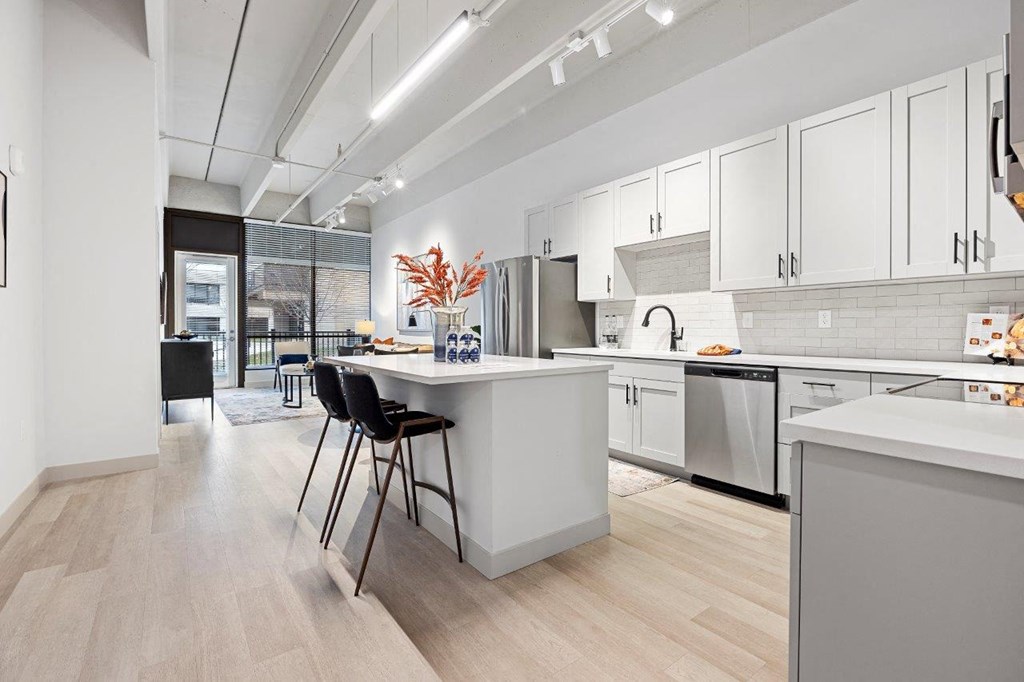 an open kitchen and dining area with a table and chairs at The Residences at Tesson Ridge, Missouri, 63128
