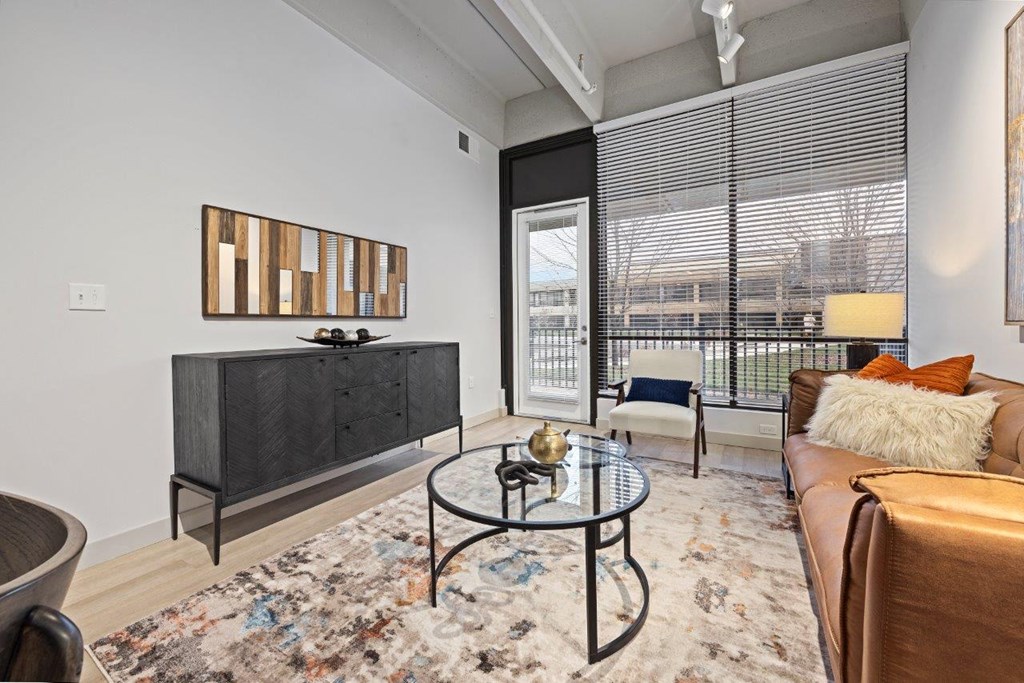 a living room with a couch and a table at The Residences at Tesson Ridge, Saint Louis, 63128