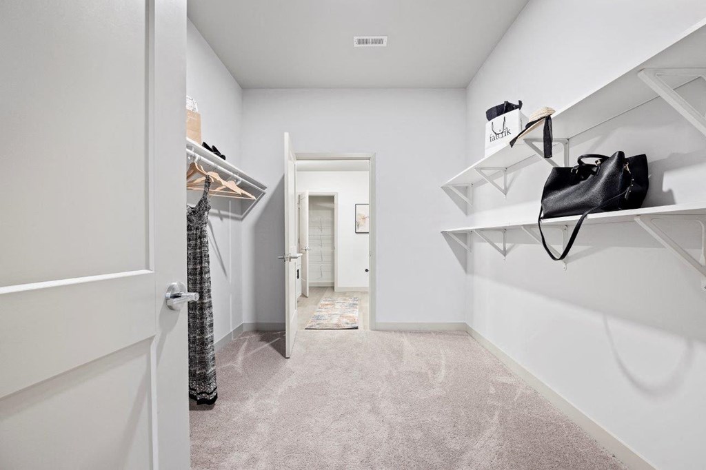 a closet in a bedroom with a door to a bathroom at The Residences at Tesson Ridge, Missouri