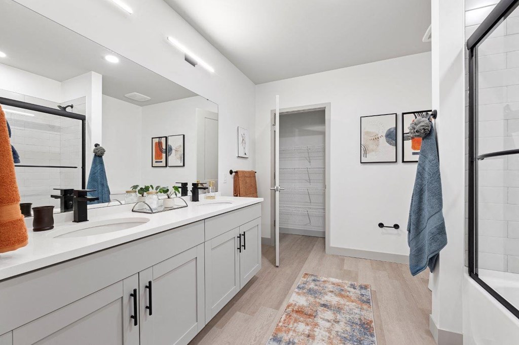 a bathroom with a sink and a shower and a mirror at The Residences at Tesson Ridge, Saint Louis, MO, 63128