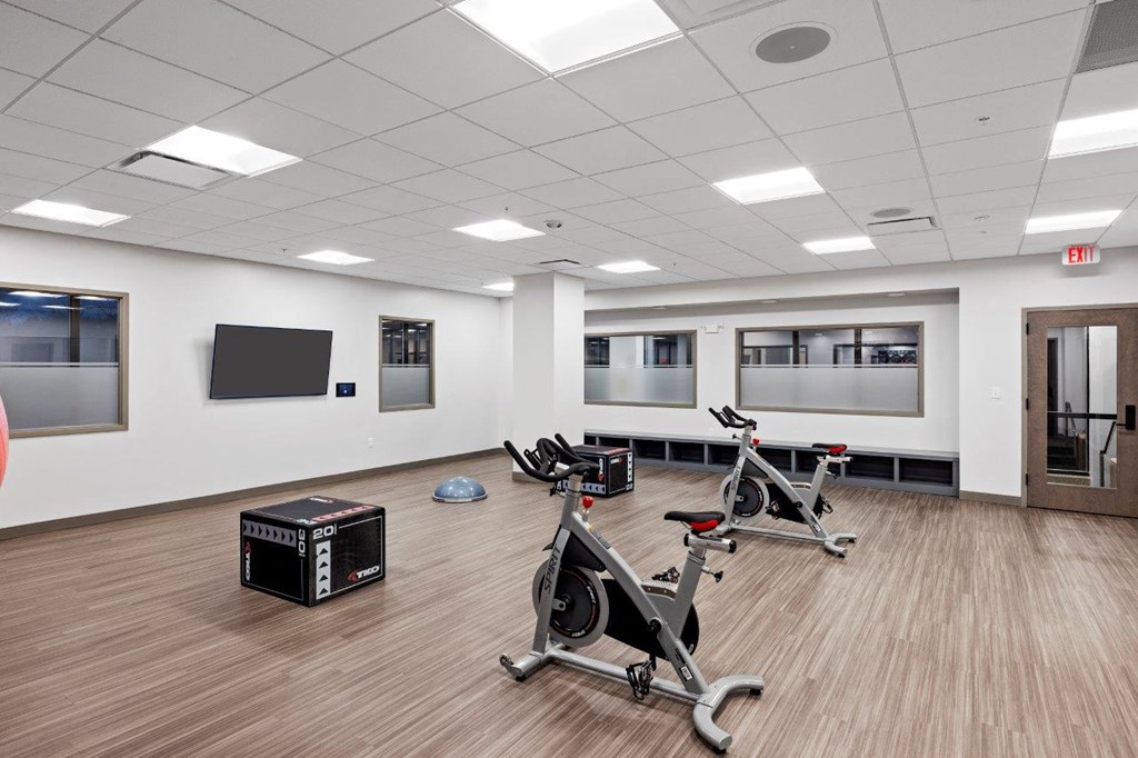 the gym in the new building has a lot of exercise bikes at The Residences at Tesson Ridge, Saint Louis, Missouri