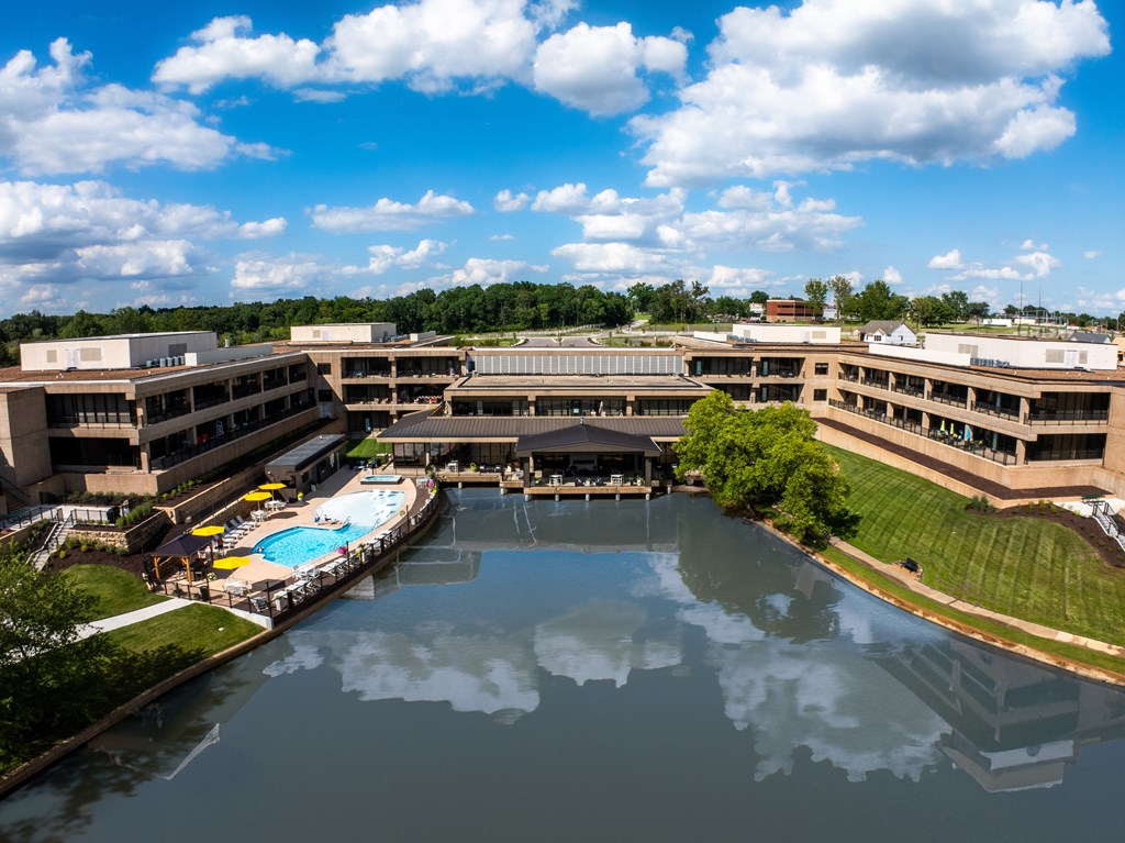 A large building complex with a pool in the middle.