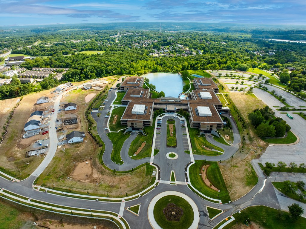A large building with a circular driveway in front of it.