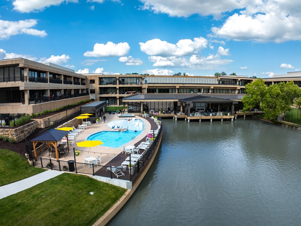 A large building with a pool in front of it.