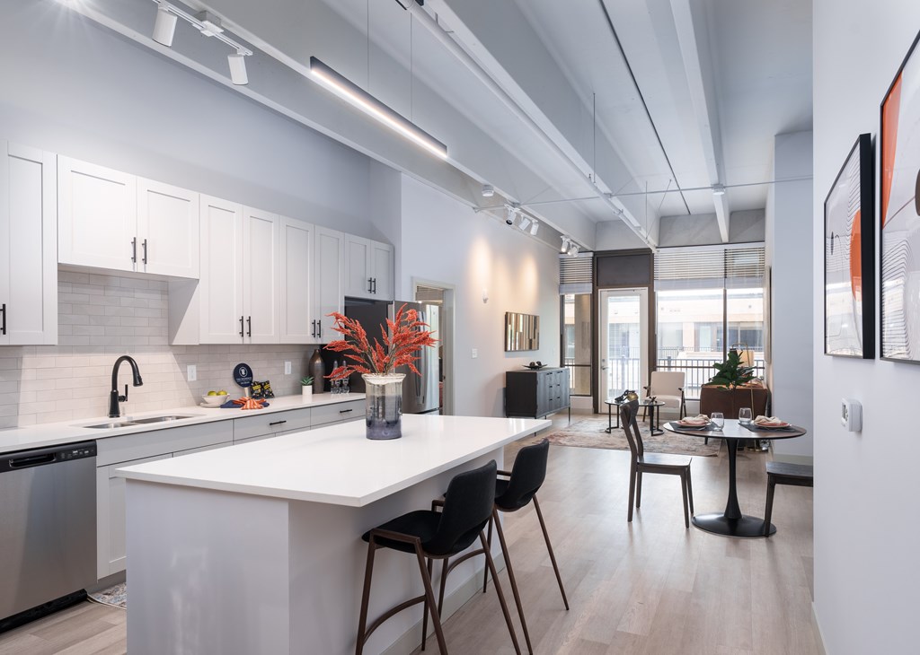 A modern kitchen with white cabinets and a large island.