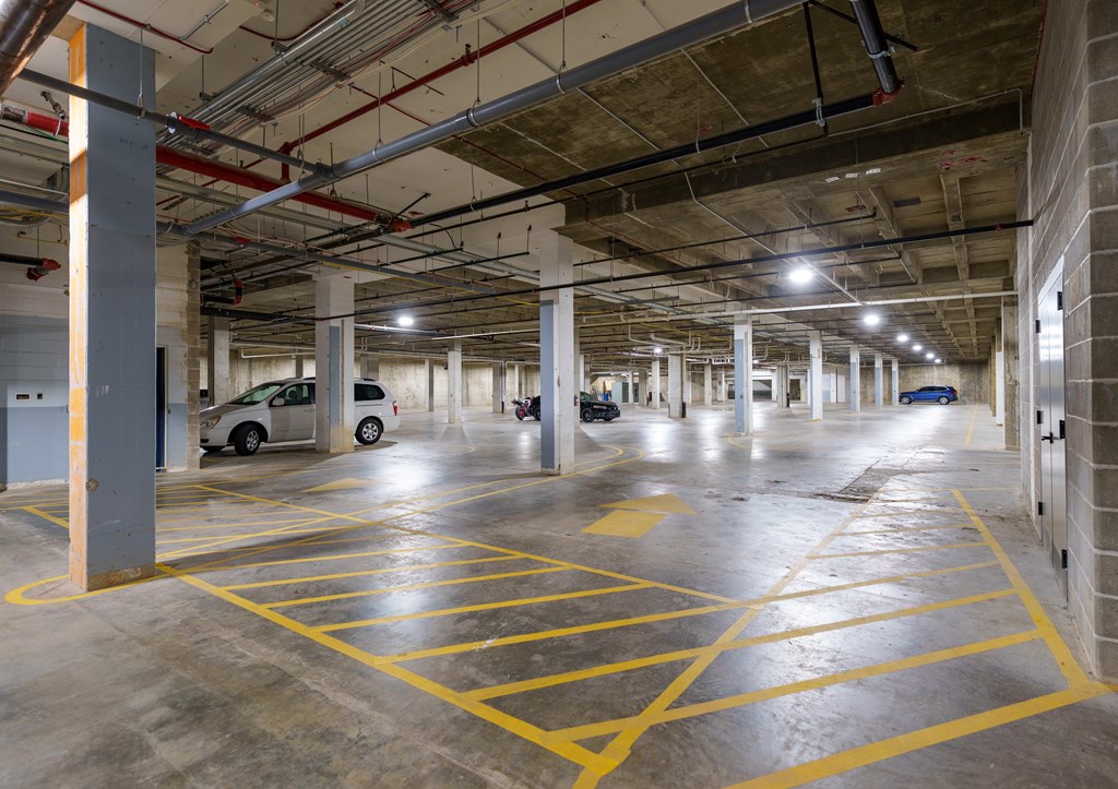 A parking garage with yellow lines on the floor.