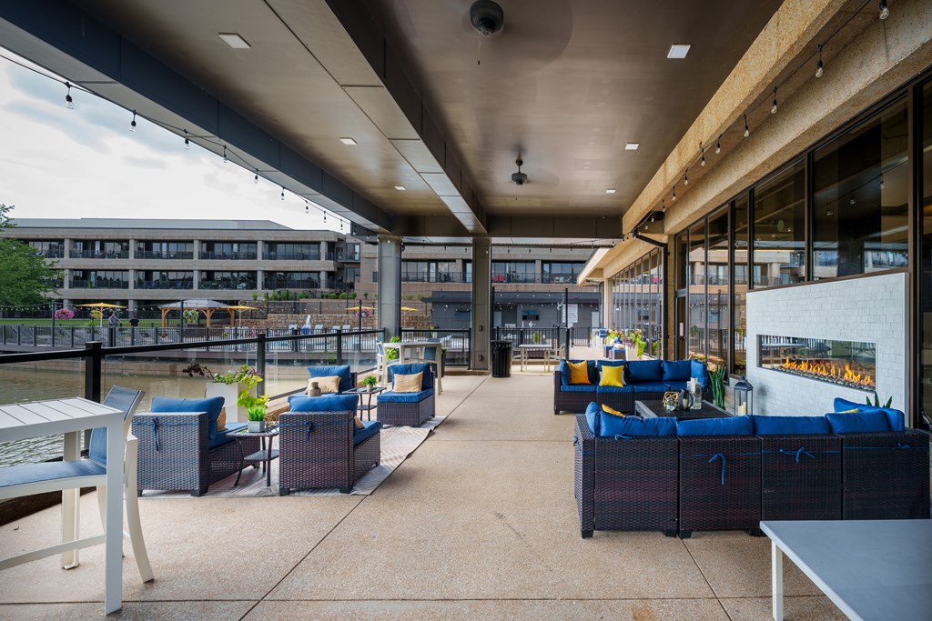 A patio area with blue couches and tables.