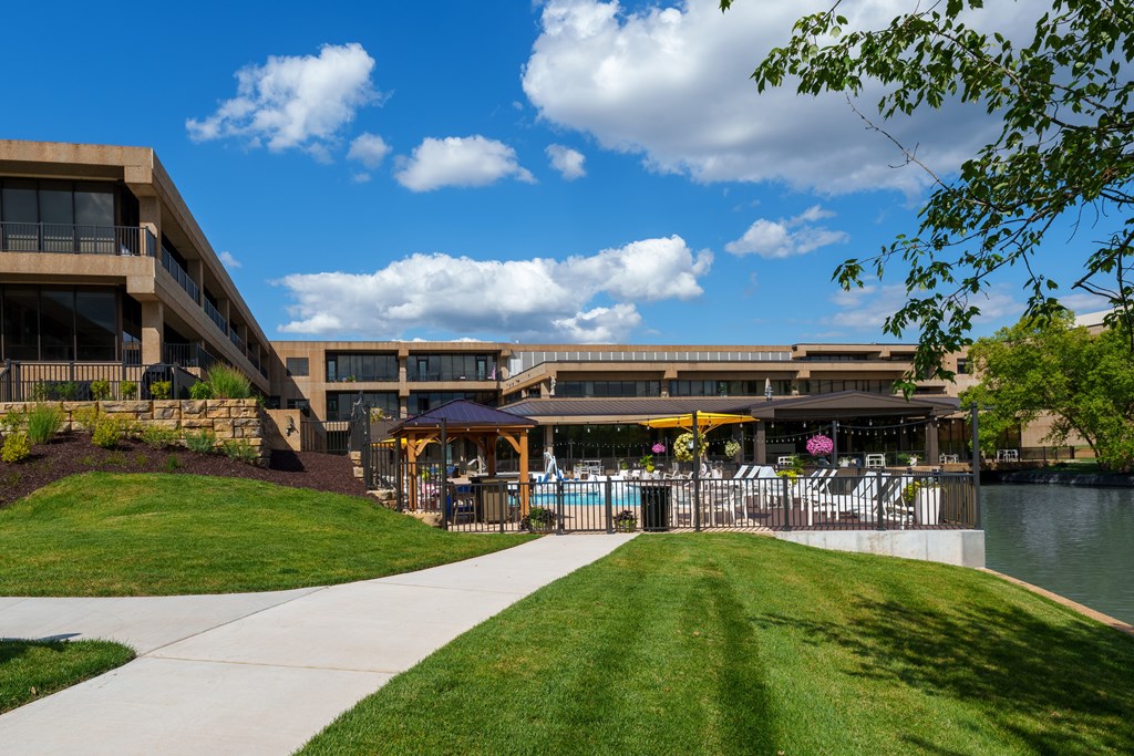 A building with a pool in front of it.