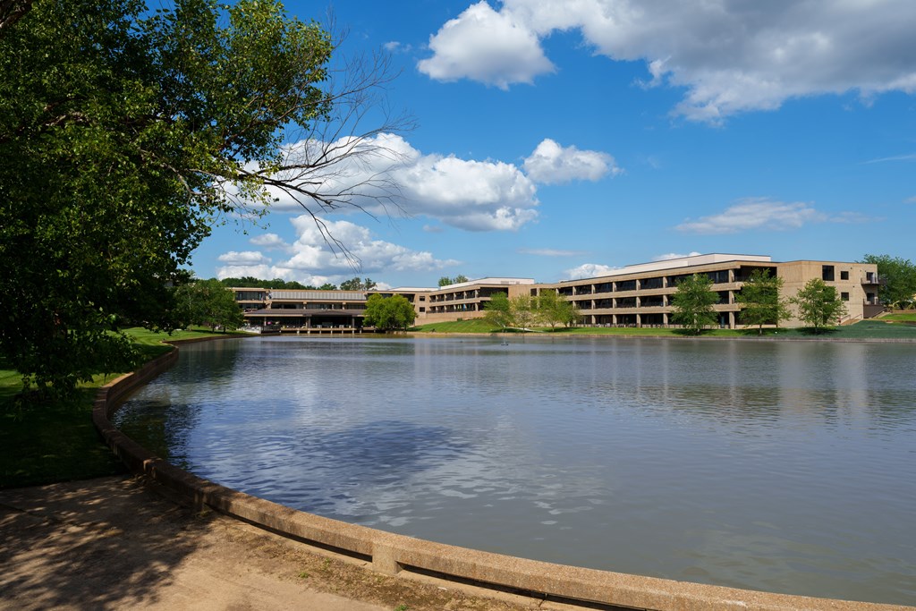 A serene lake with a building in the background.