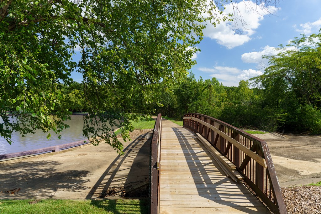 A bridge over a river with trees on the left.