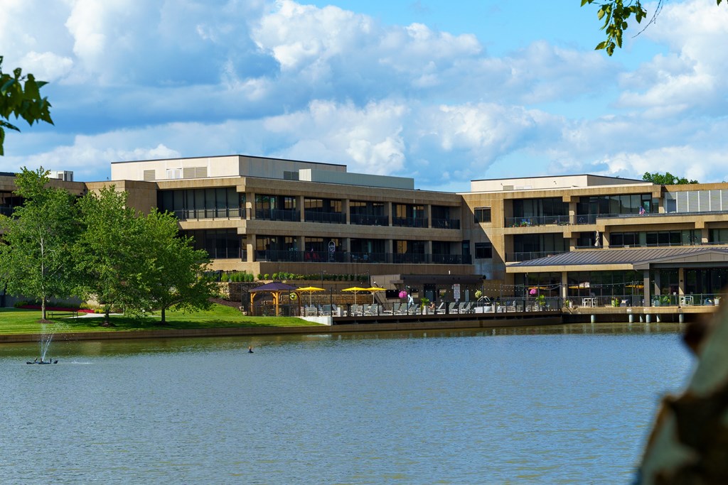 A large building with a lake in front of it.