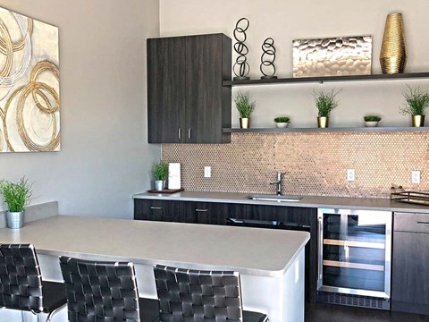 a kitchen with a counter top and chairs