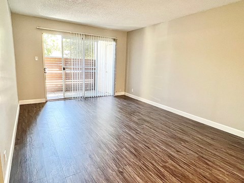 an empty living room with a sliding glass door