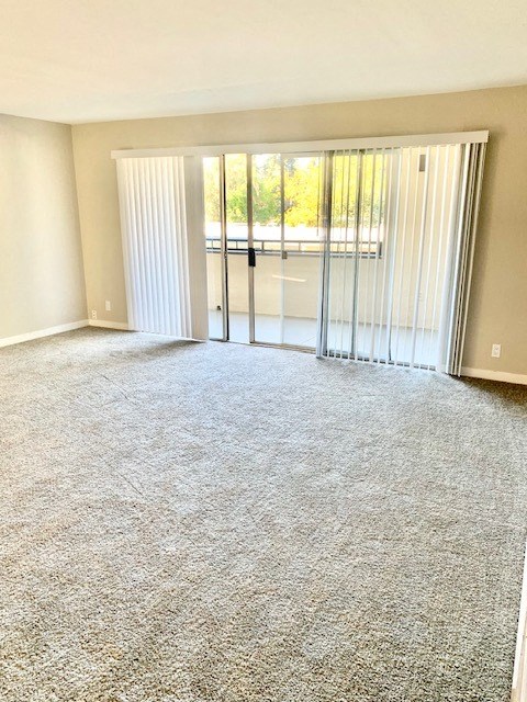 an empty living room with sliding glass doors