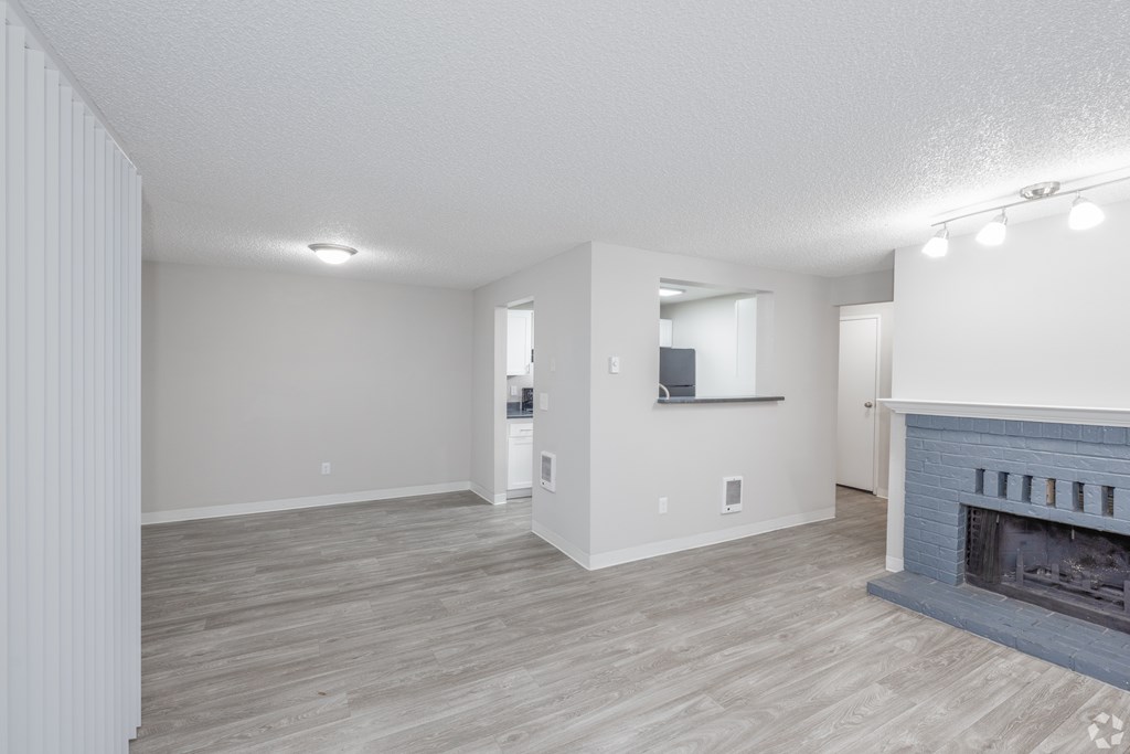 A living room with a fireplace and a television.