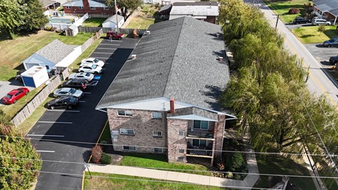 A parking lot with cars and a building in the background.